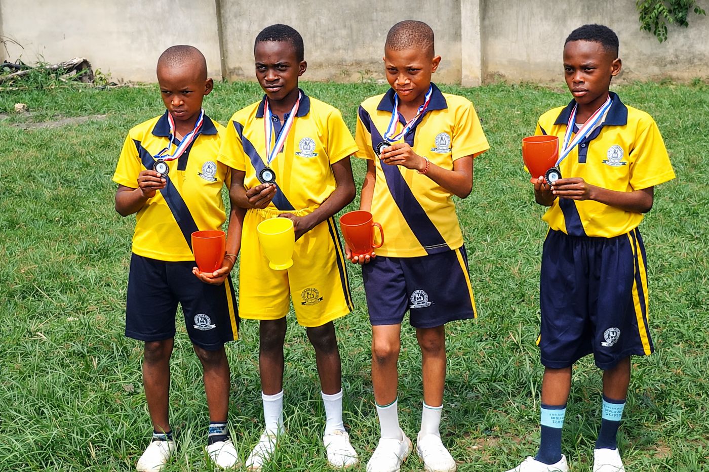Top Horizon pupils in sports uniform with medals and cups